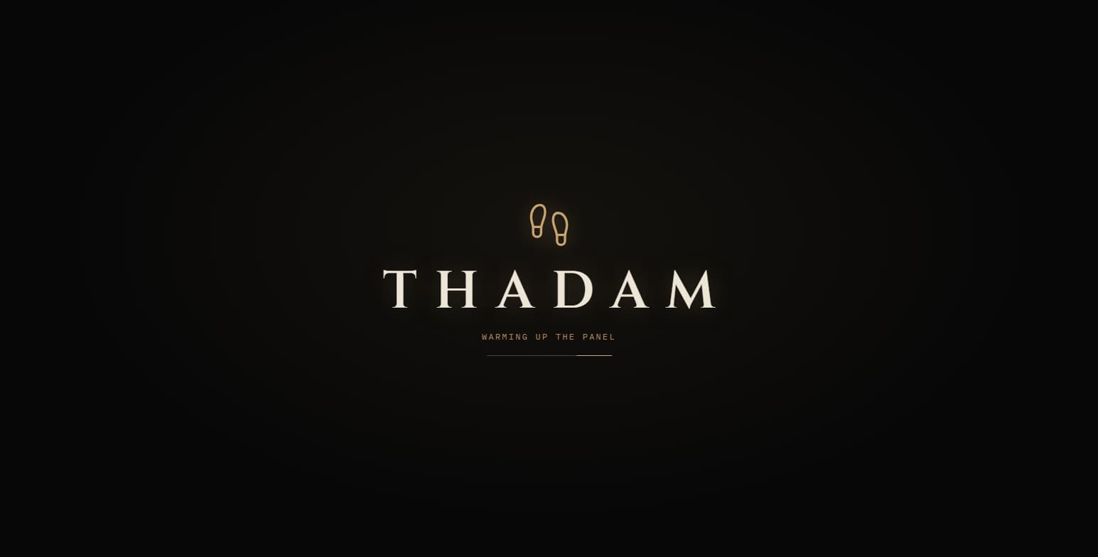 The Thadam console's splash screen: a pair of bronze footprints above the wordmark 'THADAM' on black, with the line 'Warming up the panel' above a loading bar.